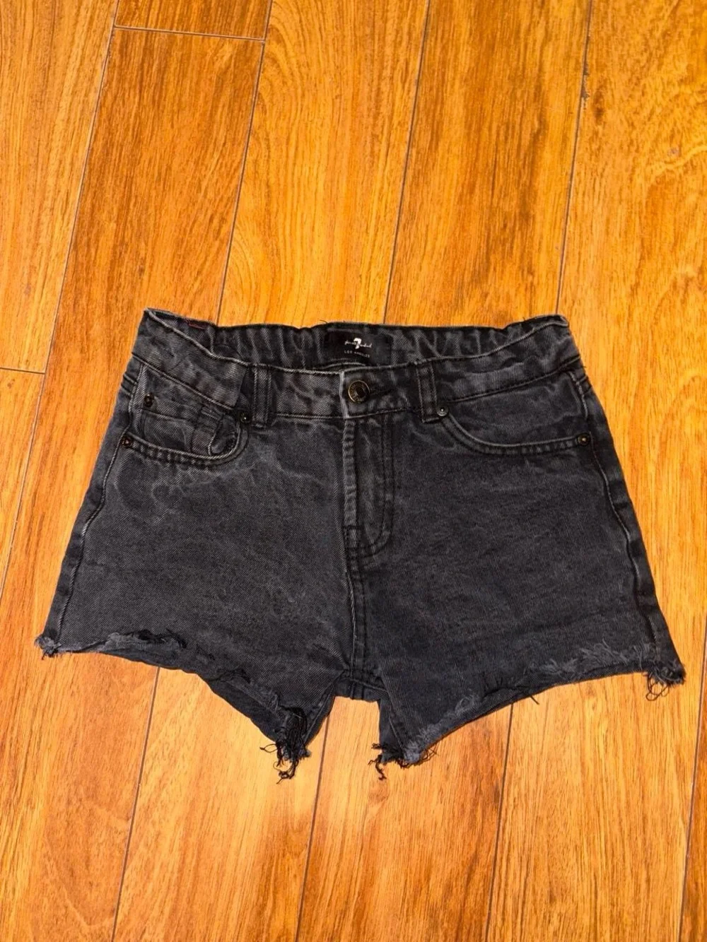 Black denim shorts with a distressed look